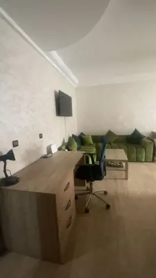 an office with a desk and a chair and a couch at Appartement sur Guéliz in Marrakech