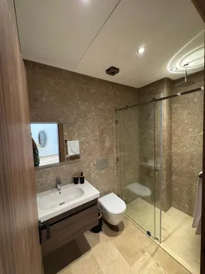 a bathroom with a toilet and a sink and a shower at Appartement Siniya Cosy à Marrakech in Marrakech