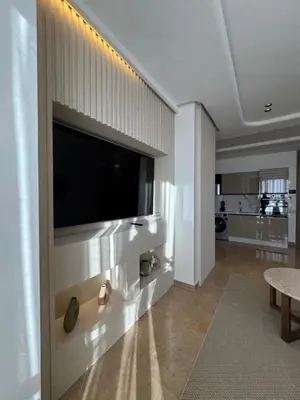 a living room with a flat screen tv on a wall at Appartement Siniya Cosy à Marrakech in Marrakech