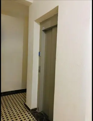 an empty hallway with a door and a tiled floor at Apartment Marrakech in Marrakech