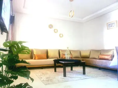 a living room with a couch and a table at Bonheur partagé 2 in Marrakech