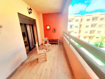 two chairs sitting on a balcony of a building at Bonheur partagé 2 in Marrakech