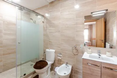 a bathroom with a toilet and a sink and a shower at Spacieux 3 chambre au Coeur de Marrakech in Marrakech