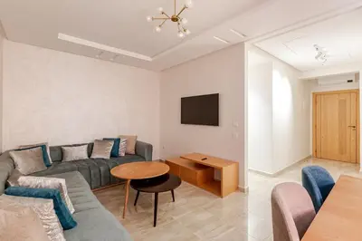 a living room with a couch and a table at Spacieux 3 chambre au Coeur de Marrakech in Marrakech