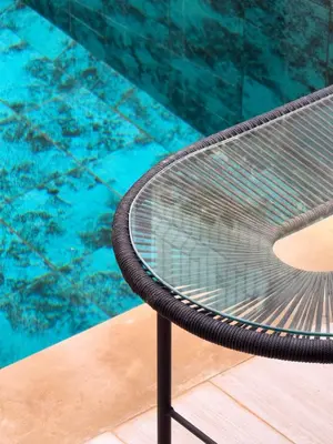 a metal bench next to a swimming pool at Maison de Vacances Targa avec Piscine & Terrasse à Marrakech in Marrakech