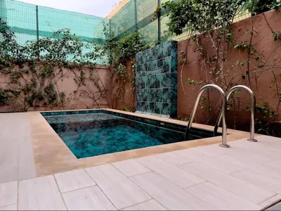 a small swimming pool with two metal rails next to a building at Maison de Vacances Targa avec Piscine & Terrasse à Marrakech in Marrakech