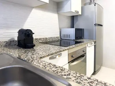 a kitchen with a sink and a laptop on a counter at Appartement tout confort à Marrakech avec Piscine et Capacité 4 Personnes in Marrakech