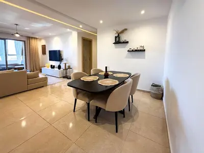 a dining table and chairs in a living room at Appartement tout confort à Marrakech avec Piscine et Capacité 4 Personnes in Marrakech