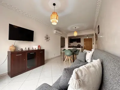 a living room with a couch and a tv at Lumière in Marrakech