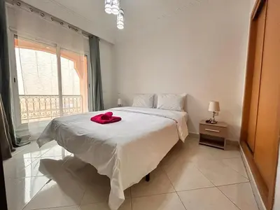 a bedroom with a bed with a red hat on it at Lumière in Marrakech