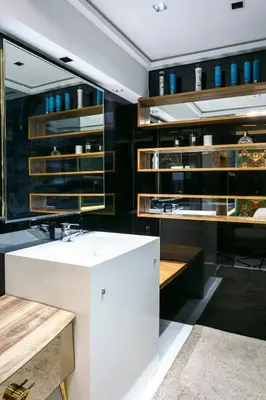 a bathroom with a white sink and wooden shelves at Une Galerie Dans Le ciel - Hivernage Marrakech in Marrakech