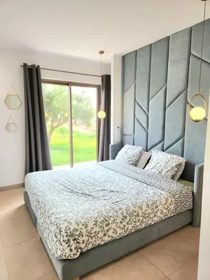 a bedroom with a large bed and a large window at Villa ilyana, Atlas Villa in Marrakech