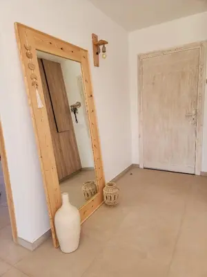 a room with a mirror and a vase on the floor at Villa ilyana, Atlas Villa in Marrakech