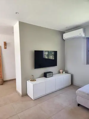 a living room with a tv on a wall at Villa ilyana, Atlas Villa in Marrakech