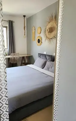 a bedroom with a large white bed and a table at Villa ilyana, Atlas Villa in Marrakech