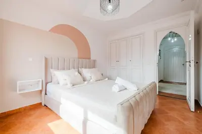a bedroom with a large white bed in a room at Cozy Studio Well Located Near Gueliz in Marrakech