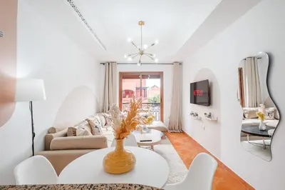 a living room with a table and a couch at Cozy Studio Well Located Near Gueliz in Marrakech
