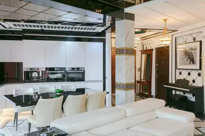 a living room with a white couch and a table at Maison Elysium Hivernage Marrakech in Marrakech