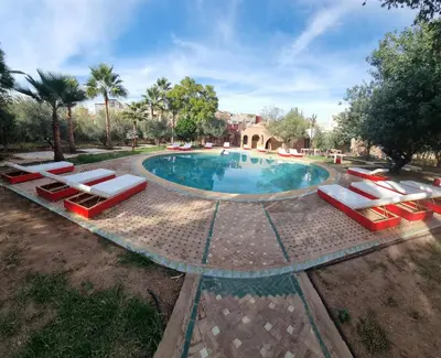 an overhead view of a swimming pool with lounge chairs around it at Dar Fatna Marrakech in Marrakech
