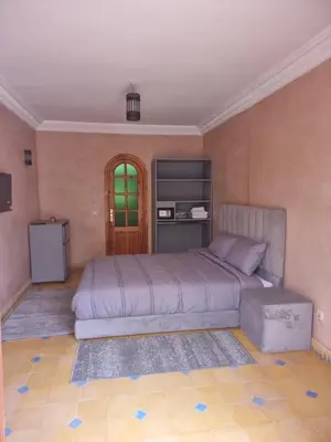 a bedroom with a large bed in a room at Dar Fatna Marrakech in Marrakech
