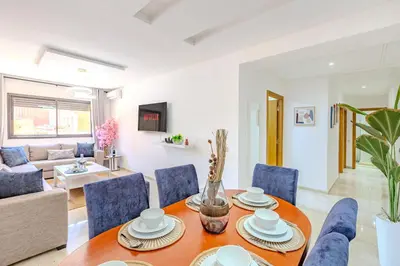a living room with a table and chairs at Appartement élégant et cosy in Marrakech