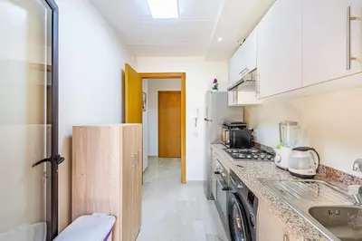 a kitchen with a sink and a stove at Appartement élégant et cosy in Marrakech