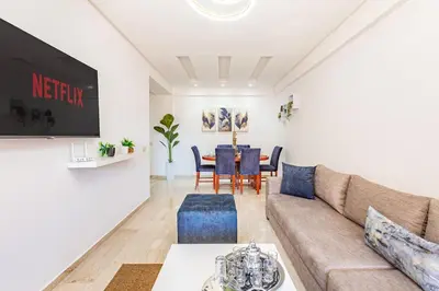 a living room with a couch and a table at Appartement élégant et cosy in Marrakech