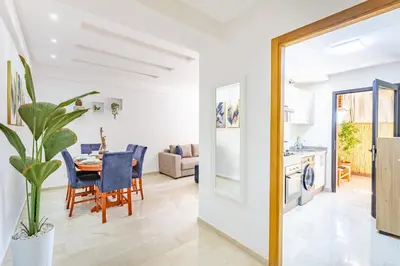 a kitchen and living room with a table and a dining room at Appartement élégant et cosy in Marrakech