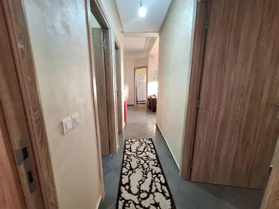 a hallway with a door and a rug at Charming Apartment at Marrakech in Marrakech