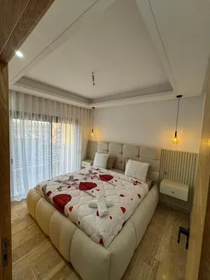 a bedroom with a large bed with red roses on it at Appartement Plaza Sunset in Marrakech