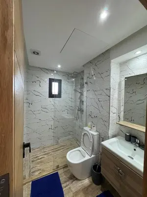 a bathroom with a toilet and a sink at Appartement Plaza Sunset in Marrakech