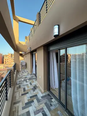 a balcony of a building with glass doors and a view at Appartement Plaza Sunset in Marrakech