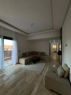 a large living room with couches and a large window at Appartement Plaza Sunset in Marrakech