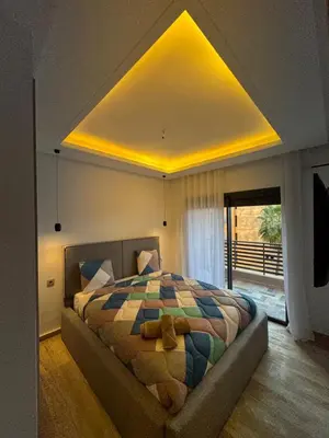 a bedroom with a bed with a teddy bear on it at Appartement Plaza Sunset in Marrakech