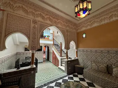 a room with a hallway with a staircase and a chandelier at ASA House in Marrakech