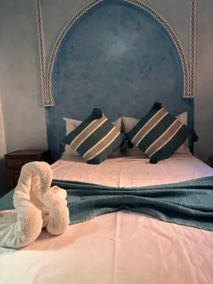 a stuffed animal is laying on a bed at ASA House in Marrakech