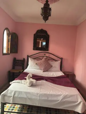 a bedroom with a bed with a teddy bear sitting on it at ASA House in Marrakech