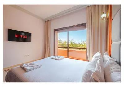 a bedroom with a bed and a large window at Villa Iris Jaccuzi, Piscine 20min Centre in Marrakech