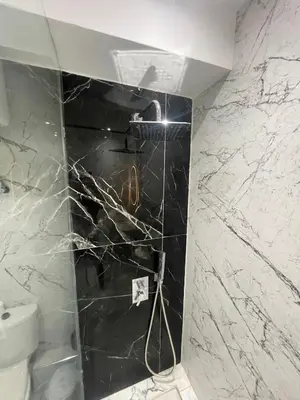 a bathroom with a black and white marble wall at Spacious Vibrant Apartment Marrakech Central - Prime Lifestyle Group in Marrakech