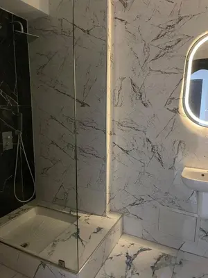 a bathroom with a shower with a toilet and a sink at Spacious Vibrant Apartment Marrakech Central - Prime Lifestyle Group in Marrakech