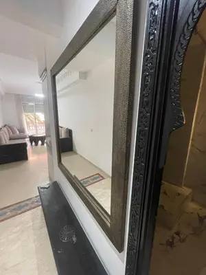 a large mirror on a wall in a living room at Spacious Vibrant Apartment Marrakech Central - Prime Lifestyle Group in Marrakech