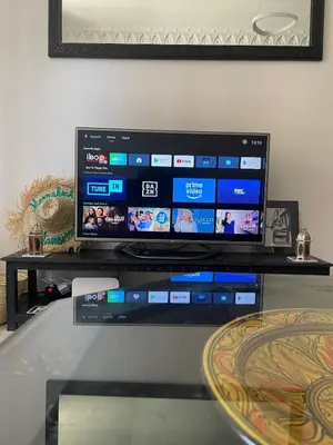 a flat screen tv sitting on top of a table at Spacious Vibrant Apartment Marrakech Central - Prime Lifestyle Group in Marrakech