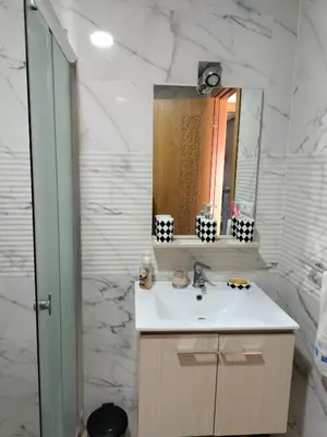 a bathroom with a sink and a mirror at Appartement Confort & Style à Charaf - Marrakech in Marrakech