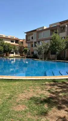 a large swimming pool in front of a building at Targa Nour in Marrakech
