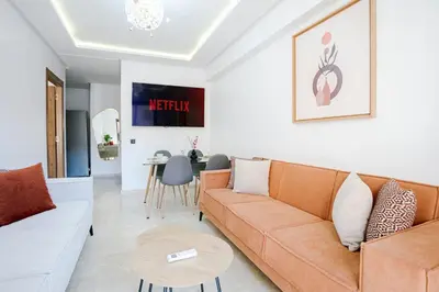 a living room with a couch and a table at Suite Art déco Piscine privée in Marrakech