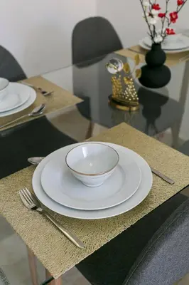a table with a white bowl and a plate on it at Suite Art déco Piscine privée in Marrakech