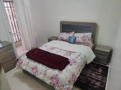 a bedroom with a bed with a blanket and pillows at Dyour marjan in Marrakech