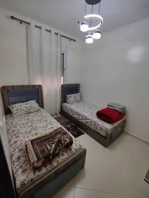two twin beds in a room with at Dyour marjan in Marrakech