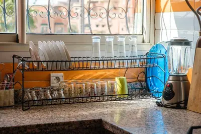 a kitchen counter with a rack of utensils at Modern 3BR Apartment 5 Min from Majorelle Garden in Marrakech