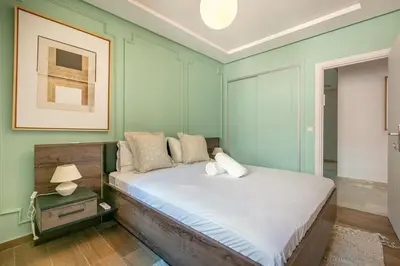 a bed in a room with green walls at Migdal Jaouhara in Marrakech